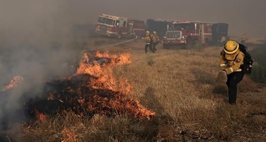 A Santa Clara Cal Fire crew scrambles to extinguish a spot fire in the median of Interstate 580, during the Corral Fire west of Tracy, Calif., Saturday, June 1, 2024. (Kent Porter/The Press Democrat via AP)