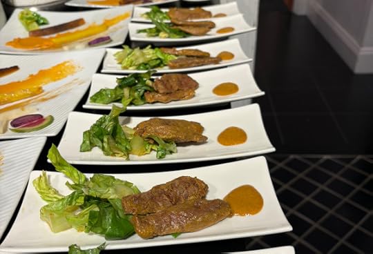 Narrow white rectangular plates each one with a bit of shredded lettuce, two slices of duck breast, and a dollop of home made Inner Beauty hot sauce. 