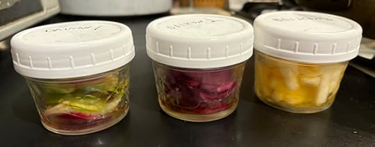 Three jars with white lids and a glimpse of their brightly colored insides