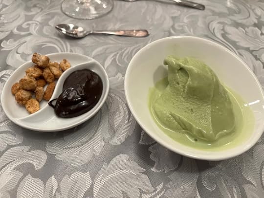 Green ice cream in one bowl, nuts and fudge in the other. 