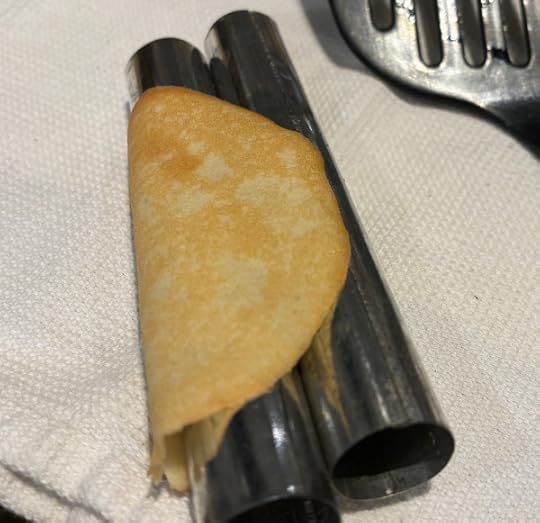 Two metal tubes with a round thing that looks like a pancake wrapped around them