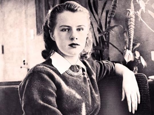 This image of Paula Jean Welden (a black-and-white portrait of a young woman in her late teens) was circulated in missing person flyers and newspapers at the time of her disappearance in 1946. She is wearing a sweater with a collared shirt and necklace, sitting with one arm beside/behind her on the back of the sofa, regarding the photographer.