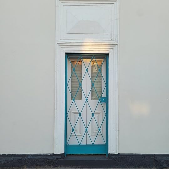 white door with teal screen