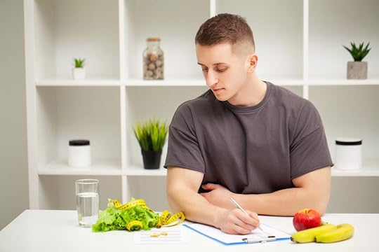 A nutrition coach writes a healthy habits plan for a client in an office.
