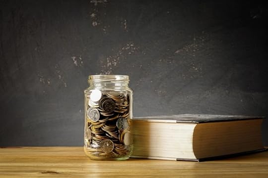 school fundraiser, jar with coins and thick book in front of chalk board
