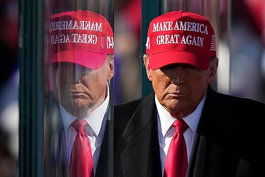 Republican presidential nominee former President Donald Trump is reflected in the bullet proof glass as he finishes speaking at a campaign rally