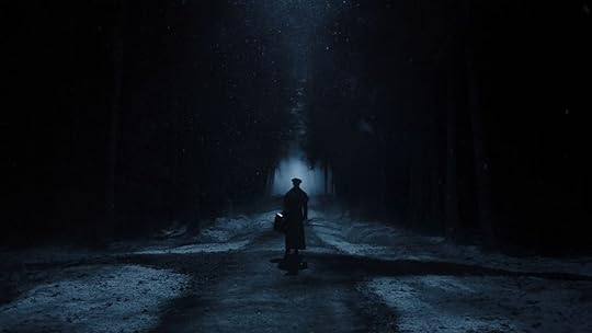 Thomas (Nicholas Hoult) walks down a dark, frigid road in Nosferatu.