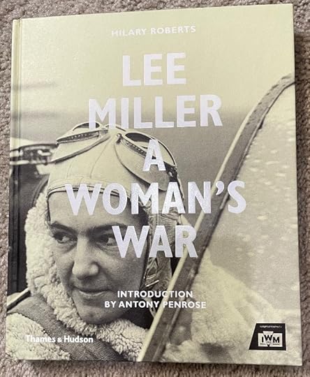Book cover of 'Lee Miller: A Woman's War' by Hilary Roberts. Cover features a black-and-white photo of a person dressed in pilot gear, looking boldly towards the camera. Text includes 'Introduction by Antony Penrose.' At the bottom are logos for Thames & Hudson and the Imperial War Museum.