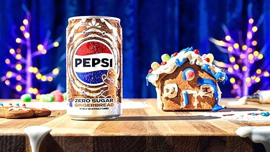 A mini can of Pepsi Gingerbread next to a small gingerbead house