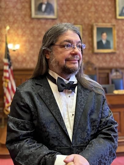 A dapper gentleman in bowtie and Chinese silk patterned long jacket. 