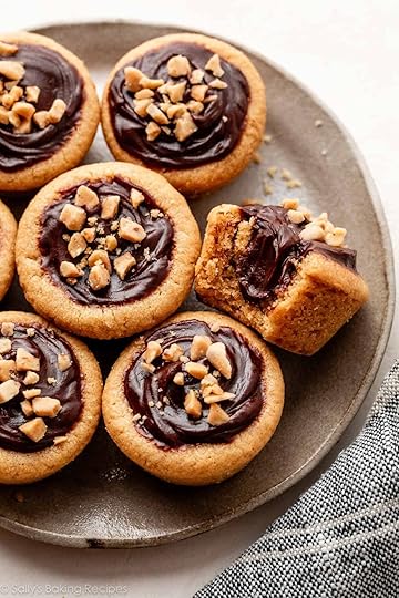 peanut butter fudge puddles with 1 bite taken out on gray plate.