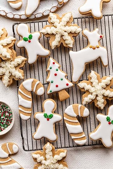 decorated brown sugar cut-out cookies in various shapes including reindeer, candy canes, and snowflakes.