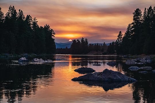 sunset over lake at paws up montana
