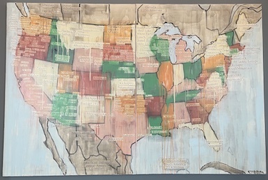 Picture of Jaune Quick-to-See Smith's painting Tribal Map (2000-2001) at the Walter E. Washington Convention Center in Washington, D.C., in 2022. A painting of a map of the United States, with the states outlined and each state a different color. Some of the paint has dripped from the states and is covering other portions of the work. Labels are attached to the map noting major Native American tribes and civilizations and where they lived.