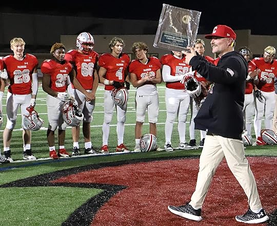 Carmel High School football coach Golden Anderson holds the title...