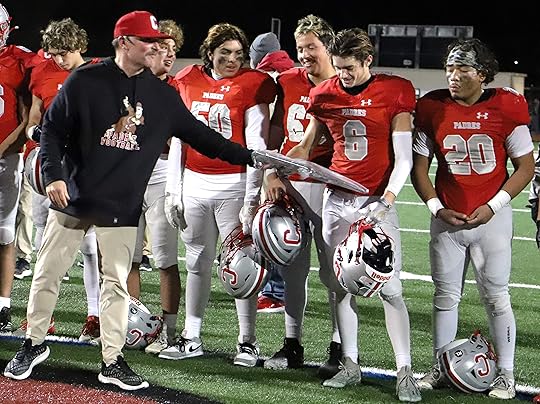 Carmel football coach Golden Anderson hands the Northern California Division...