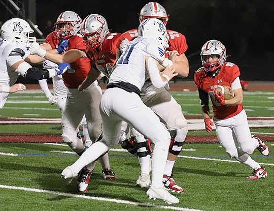Carmel back Dylan Hinds gains yardage in the second quarter...
