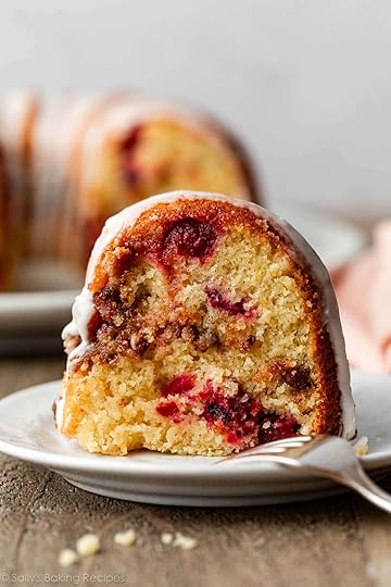 cranberry orange Bundt cake slice on white plate.