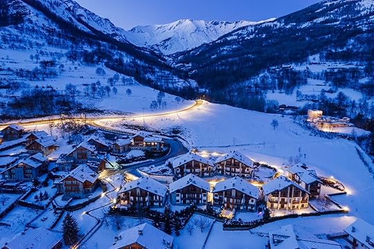 Panoramic view from above at nightfall of the snowy village of Bardonecchia, a ski resort in the Alps in Piedmont, Italy.