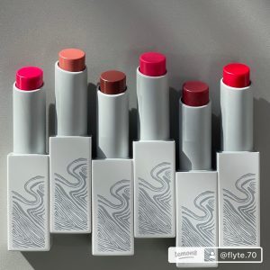 Six brightly colored lipsticks in sporty white tubes