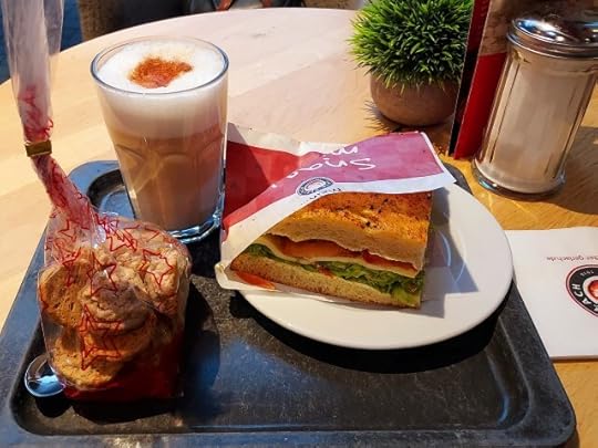Latte macchiato, cookies and tomato mozarella sandwich