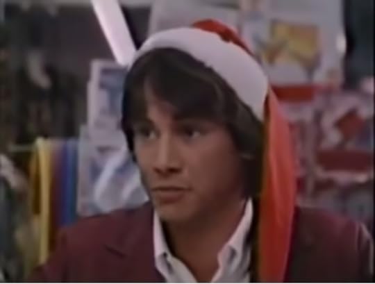 A young Keanu Reeves, wearing a santa hat.