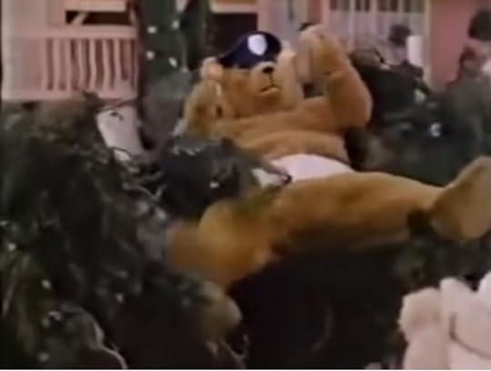 A human in a teddy bear policeman costume being dragged off by ghoulish characters.