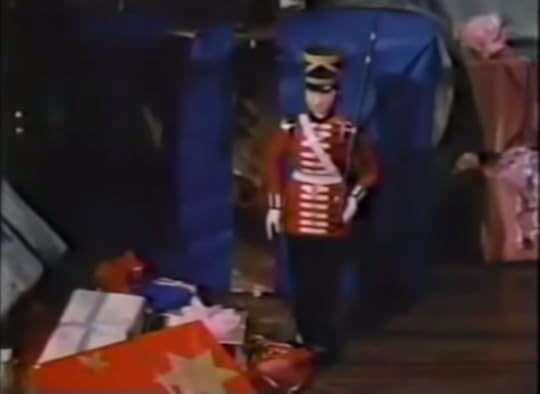 A smaller version of the aforementioned toy soldiers beside a bunch of Christmas presents.