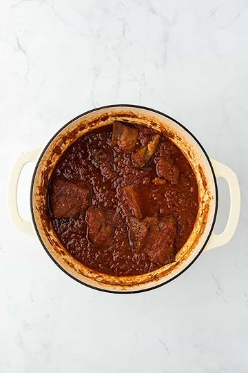 Baked short rib ragu in a large dutch oven on a white countertop