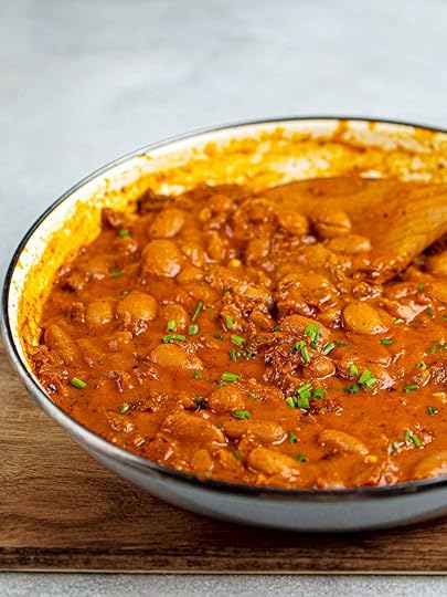 creamy butter beans in tomato sauce in a skillet