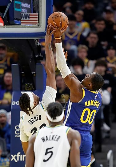 Golden State Warriors’ Jonathan Kuminga #00 has his shot blocked...