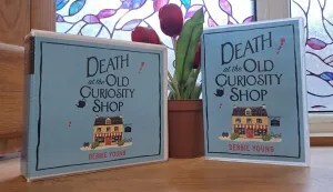 photo of boxed audiobook disks with pot of red tulips