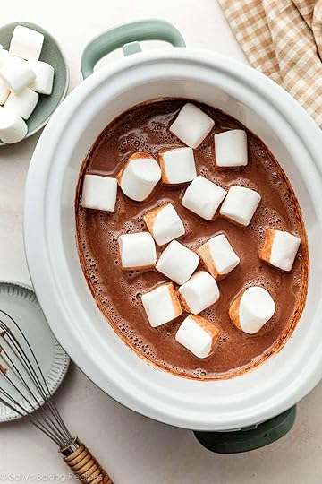 homemade hot chocolate drink in slow cooker with marshmallows floating on top.
