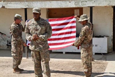 Spc. Ryan Cooley, 101st Airborne Division, reenlists in the Army for another five years on Camp Taji, Iraq, in 2019. Photo by Maj. Vonnie L. Wright, courtesy of the U.S. Army. 