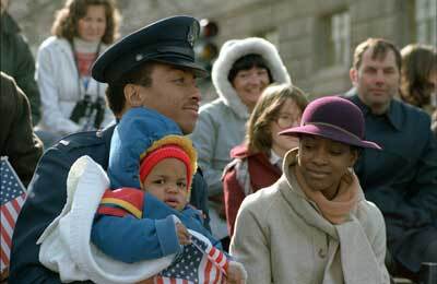 An Air Force second lieutenant watches the parade on Inauguration Day 1981 with his wife and child. Photo by Gary Kieffer, courtesy of the National Archives. 