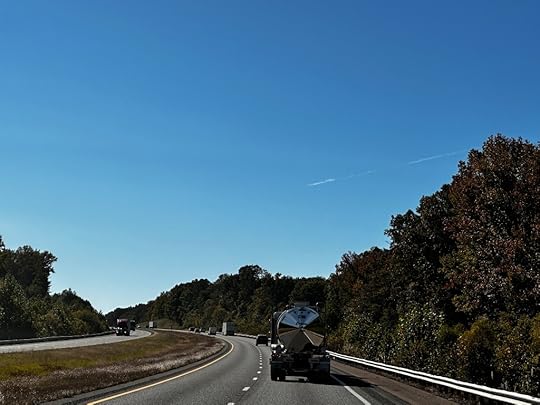 Highway, trucks and cars, blue sky, trees