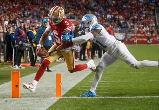 San Francisco 49ers' Joshua Dobbs (5) scores a touchdown against Detroit Lions' Kerby Joseph (31) in the fourth quarter at Levi's Stadium in Santa Clara, Calif., on Monday, Dec. 30, 2024. (Nhat V. Meyer/Bay Area News Group)
