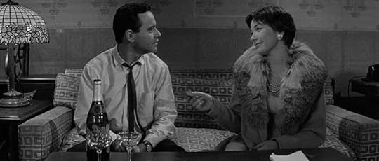 Jack Lemmon and Shirley MacLaine sit on the couch in The Apartment (1960)