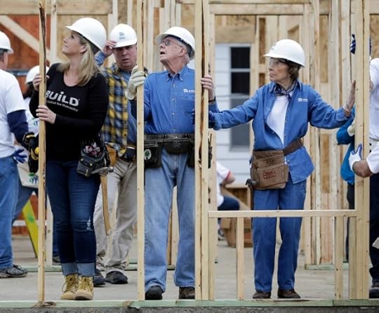 Former President Jimmy Carter works between his wife, Rosalynn Carter, right, and singer Trisha Yearwood, left, at a Habitat for Humanity building site Monday, Nov. 2, 2015, in Memphis, Tenn. Behind Yearwood is her husband, singer Garth Brooks. Carter and his wife, Rosalynn, have volunteered a week of their time annually to Habitat for Humanity since 1984, events dubbed 