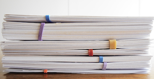 Pile of index cards, grouped in sections with coloured rubber bands