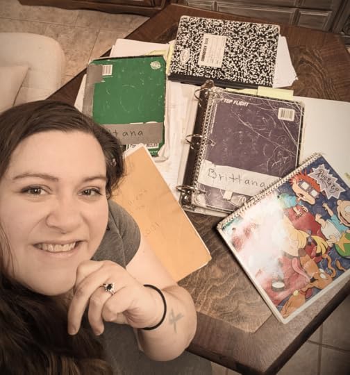A picture of me with all my notebooks I filled up as a young writer before I typed all my stories.
