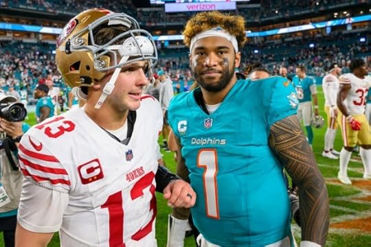 Miami Dolphins quarterback Tua Tagovailoa (1) and San Francisco 49ers quarterback Brock Purdy (13) talk on the field after an NFL football game, Sunday, Dec. 22, 2024, in Miami Gardens, Fla. (AP Photo/Doug Murray)