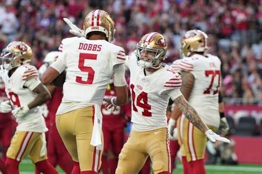 San Francisco 49ers wide receiver Ricky Pearsall (14) celebrates his touchdown catch with quarterback Joshua Dobbs (5) during the first half of an NFL football game in Glendale, Ariz., Sunday, Jan. 5, 2025. (AP Photo/Rick Scuteri)