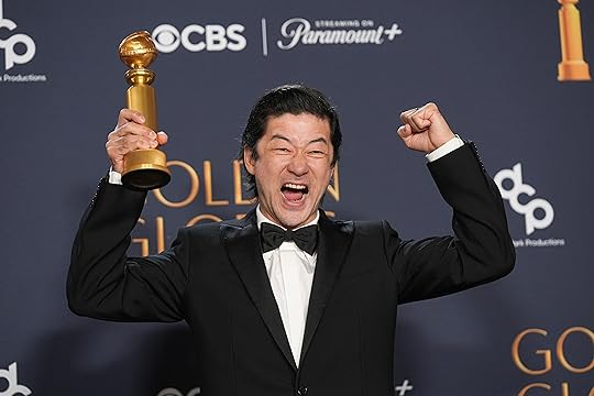 Tadanobu Asano poses in the press room with the award...