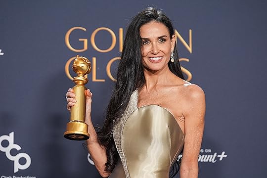 Demi Moore poses in the press room with the award...