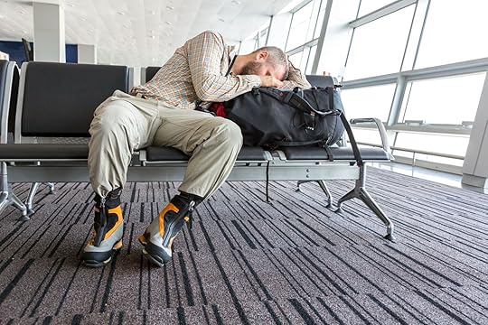 guy sleeping in airport chair