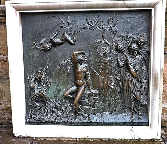 A photograph of the square bronze frieze described in the main text: in the middle Andromeda sits on a stack of stones which look conspicuously like the stones the Palazzo Vecchio itself is made of (the seat of government and symbol of the city). Above her, Perseus flies down with upraised sword to slay the sea dragon which threatens her from the bottom left. To the right, mourning citizens watch the dramatic scene, but above and behind them men on horses clash and the pikes and halberds of German-style soldiers of the era the statue was made stick up above the crowd.