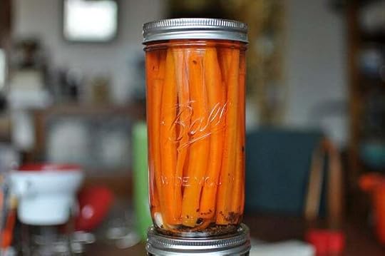 Pint and a half jar filled with long pickled carrot sticks.