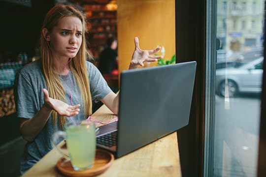 Woman on a zoom call looking frustrated