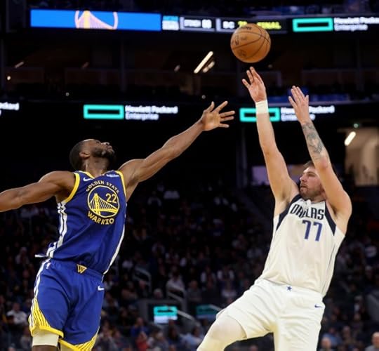 Dallas Mavericks' Luka Doncic #77 shoots a 3-point basket o ver Golden State Warriors' Andrew Wiggins #22 in the fourth quarter of their NBA game at the Chase Center in San Francisco, Calif., on Sunday, Dec. 15, 2024. (Jane Tyska/Bay Area News Group)